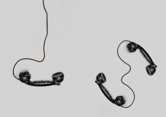 Two old black telephones with cord
